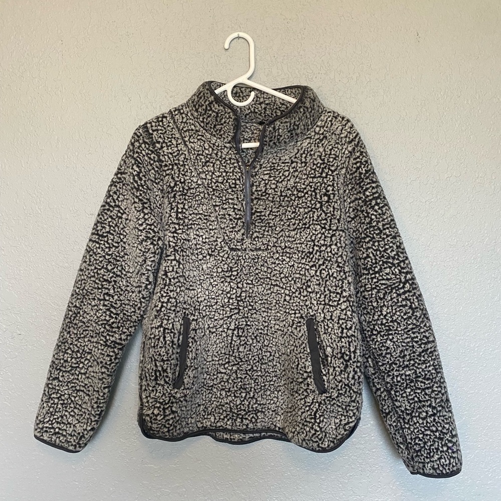 Black and grey fuzzy half zip up sweater with pockets, size medium.